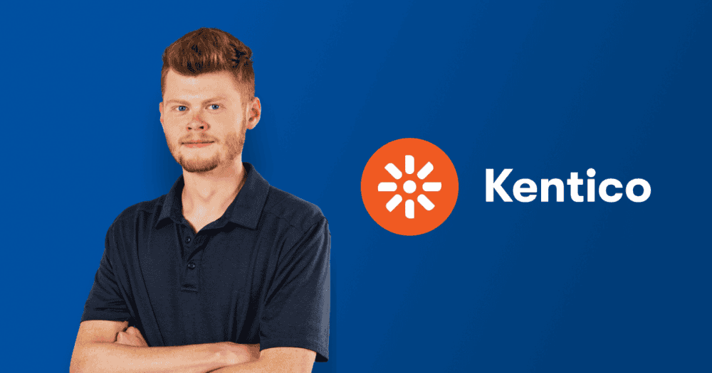 The image features a young man with reddish hair and a beard, wearing a dark polo shirt, standing against a blue background. He has his arms crossed and is looking confidently at the camera. To his right, there is the Kentico logo, which consists of an orange circle with a white sunburst design inside it, and the word "Kentico" written in white text next to the logo.