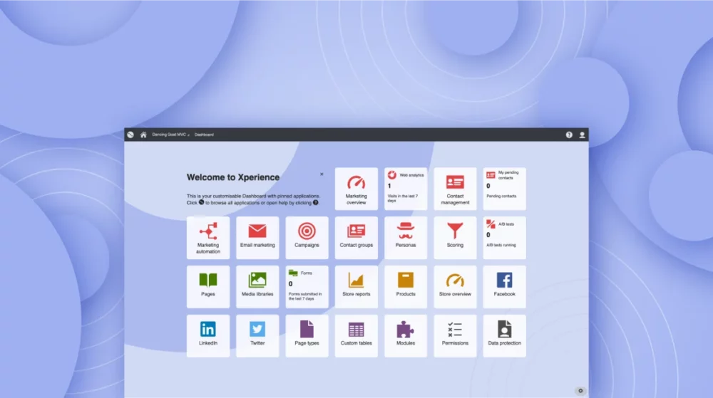 The image showcases the Kentico Xperience dashboard with a customizable interface. The dashboard is titled "Welcome to Xperience" and displays various application icons in a grid layout, including "Marketing automation," "Email marketing," "Pages," "Media libraries," "Facebook," and more. Above the grid, there's a navigation bar with the title "Dancing Goat MVC," and in the background, there is a soft purple and blue gradient with circular ripple designs, creating a modern and clean aesthetic.