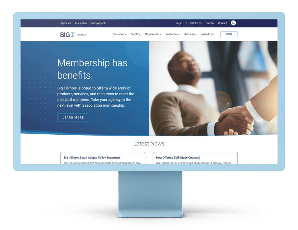 Desktop monitor displaying the Big I Illinois website homepage with the headline 'Membership has benefits.' The page highlights services and resources for members, along with a prominent 'Learn More' button and a section showcasing the latest news updates.